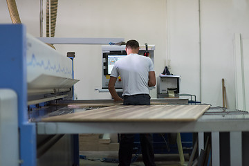 Image showing worker in a factory of wooden furniture