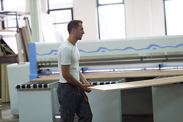 Image showing worker in a factory of wooden furniture