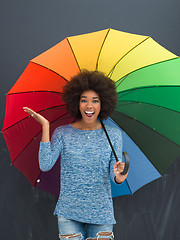 Image showing african american woman holding a colorful umbrella