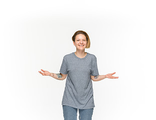 Image showing Closeup of young woman\'s body in empty gray t-shirt isolated on white background. Mock up for disign concept