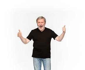 Image showing Closeup of senior man\'s body in empty black t-shirt isolated on white background. Mock up for disign concept