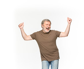 Image showing Closeup of senior man\'s body in empty brown t-shirt isolated on white background. Mock up for disign concept