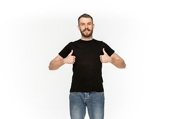 Image showing Closeup of young man\'s body in empty black t-shirt isolated on white background. Mock up for disign concept