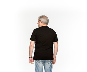 Image showing Closeup of senior man\'s body in empty black t-shirt isolated on white background. Mock up for disign concept