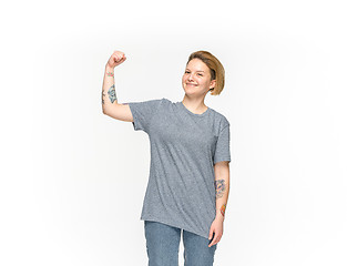 Image showing Closeup of young woman\'s body in empty gray t-shirt isolated on white background. Mock up for disign concept