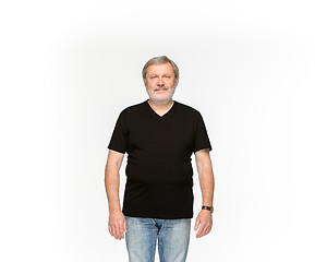 Image showing Closeup of senior man\'s body in empty black t-shirt isolated on white background. Mock up for disign concept