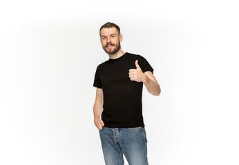 Image showing Closeup of young man\'s body in empty black t-shirt isolated on white background. Mock up for disign concept