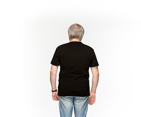 Image showing Closeup of senior man\'s body in empty black t-shirt isolated on white background. Mock up for disign concept