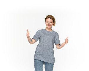 Image showing Closeup of young woman\'s body in empty gray t-shirt isolated on white background. Mock up for disign concept