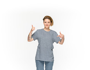 Image showing Closeup of young woman\'s body in empty gray t-shirt isolated on white background. Mock up for disign concept