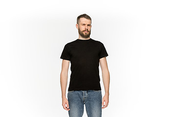 Image showing Closeup of young man\'s body in empty black t-shirt isolated on white background. Mock up for disign concept