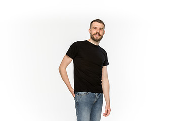 Image showing Closeup of young man\'s body in empty black t-shirt isolated on white background. Mock up for disign concept