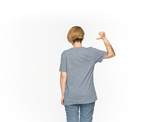 Image showing Closeup of young woman\'s body in empty gray t-shirt isolated on white background. Mock up for disign concept