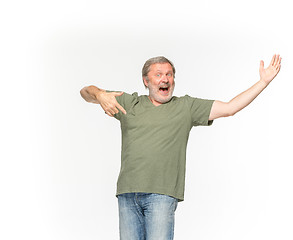 Image showing Closeup of senior man\'s body in empty green t-shirt isolated on white background. Mock up for disign concept