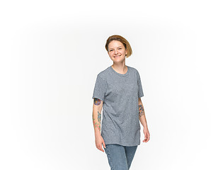 Image showing Closeup of young woman\'s body in empty gray t-shirt isolated on white background. Mock up for disign concept