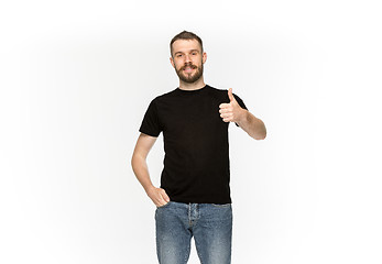 Image showing Closeup of young man\'s body in empty black t-shirt isolated on white background. Mock up for disign concept