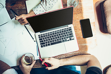 Image showing The hands of people working and relaxing in pub.