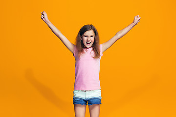 Image showing Happy success teen girl celebrating being a winner. Dynamic energetic image of female model