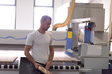 Image showing worker in a factory of wooden furniture