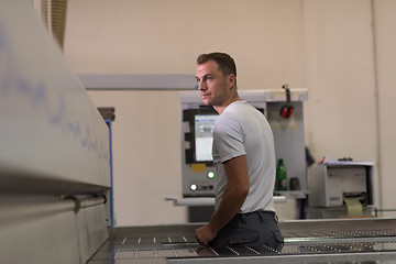 Image showing worker in a factory of wooden furniture