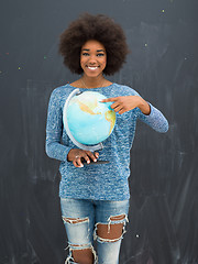 Image showing black woman holding Globe of the world