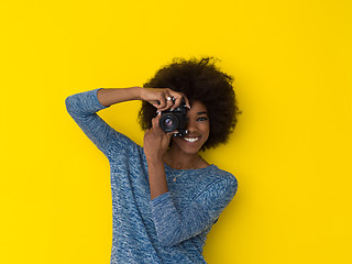 Image showing young african american girl taking photo on a retro camera