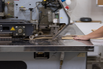 Image showing engineer in front of wood cutting machine