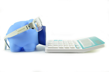 Image showing Piggy bank with eye glasses and calculator