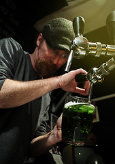 Image showing Pouring the green beer