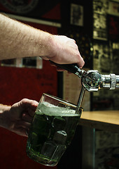 Image showing Pouring the green beer