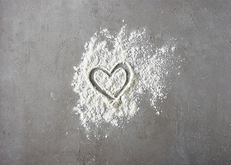 Image showing heart shape in flour on grey kitchen table