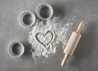 Image showing heart shape in flour and baking equipment 