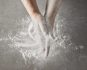 Image showing baker hands with flour in motion