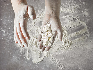 Image showing baker hands with flour in motion