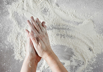 Image showing baker hands with flour in motion