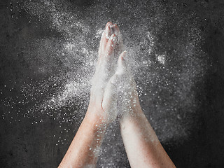 Image showing baker hands with flour in motion