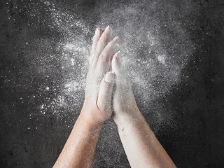 Image showing baker hands with flour in motion