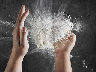 Image showing baker hands with flour in motion