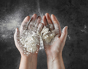 Image showing baker hands with flour in motion