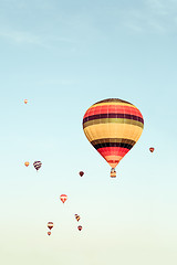 Image showing Colorful hot air balloons flying in the distance