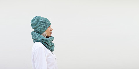 Image showing Pretty woman in warm turquoise knitted hat