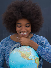 Image showing black woman holding Globe of the world