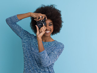 Image showing african american girl taking photo on a retro camera