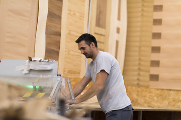 Image showing worker in a factory of wooden furniture