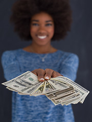 Image showing black woman holding money on gray background