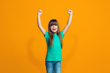 Image showing Happy success teen girl celebrating being a winner. Dynamic energetic image of female model