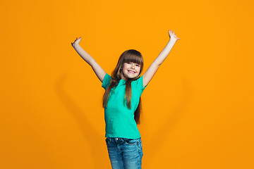 Image showing Happy success teen girl celebrating being a winner. Dynamic energetic image of female model