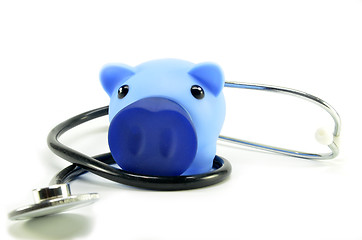 Image showing Stethoscope and piggy bank