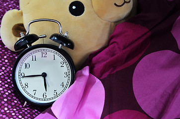 Image showing Retro alarm clock and brown teddy bear