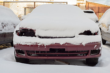 Image showing Front of abandoned car covered with snow.